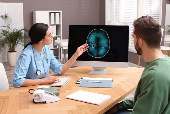 Médecin expliquant le fonctionnement du système nerveux autonome sur un écran pour diagnostiquer une dysautonomie.
